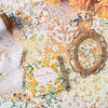 A collection of vintage floral scrapbook paper sheets featuring yellow and orange flowers, leaves, and butterflies.