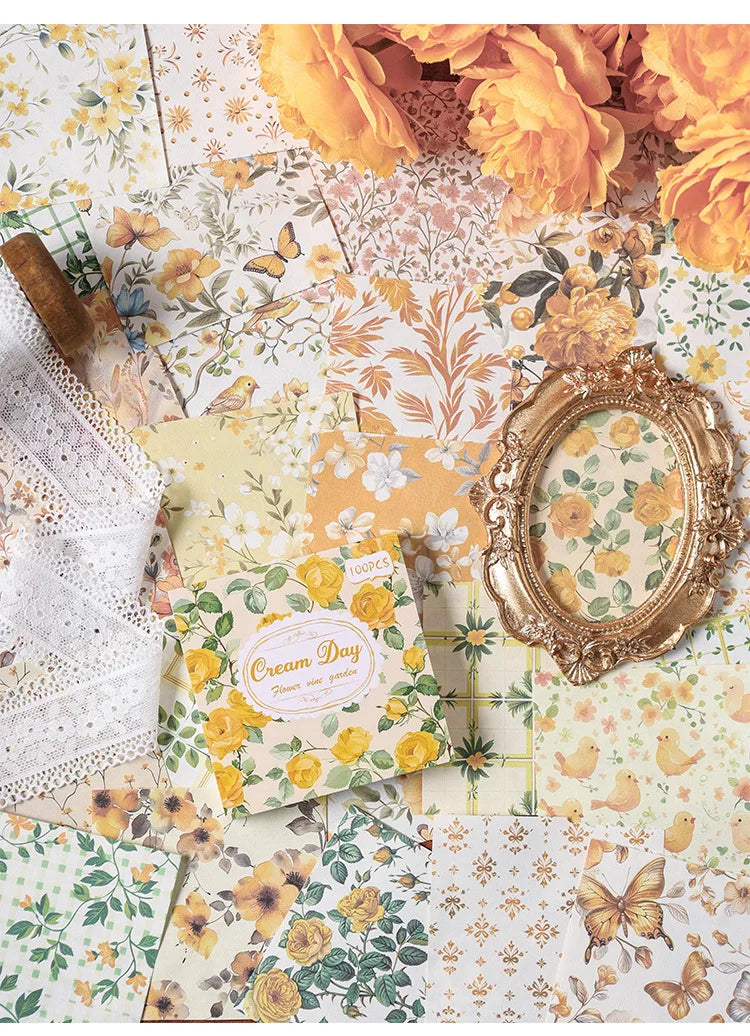 A collection of vintage floral scrapbook paper sheets featuring yellow and orange flowers, leaves, and butterflies.
