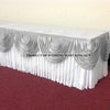 Elegant ice silk table skirt with matching top swag displayed on a white table.