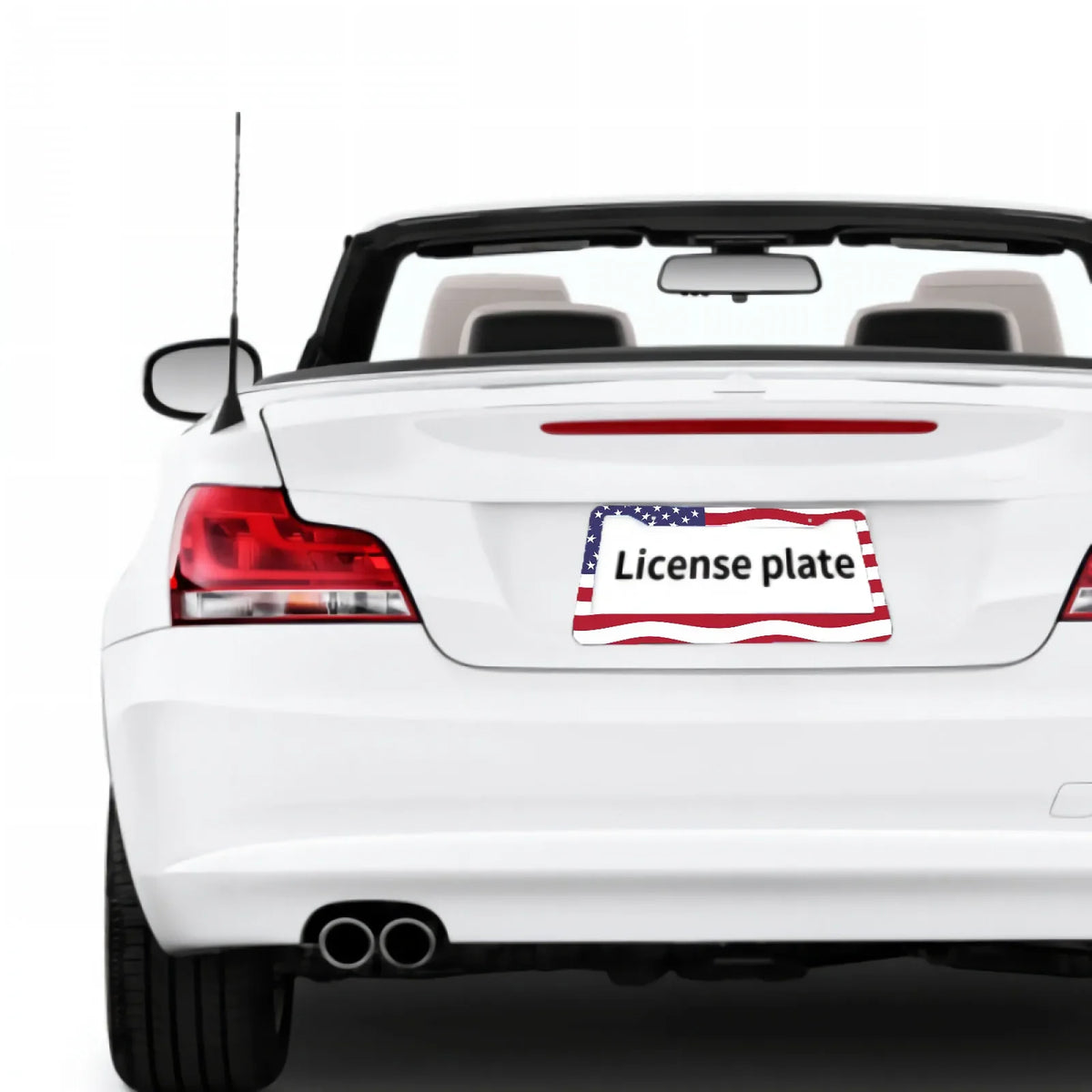 A white car with a license plate frame displaying the American flag design on the rear bumper.