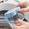 A hand is opening a blue filter bag for a washing machine lint and hair catcher filter.