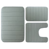 A set of three gray plush memory foam bath mats with non-slip backing.