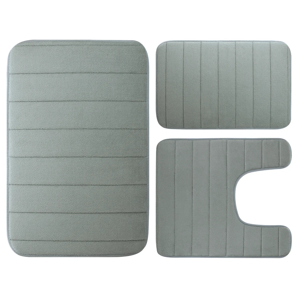 A set of three gray plush memory foam bath mats with non-slip backing.