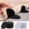 Close-up of heavy-duty self-adhesive hook-and-loop tape in black and beige used to secure car mats or rugs.