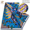 A bolt of pink glitter African wax print fabric featuring blue, purple, and yellow floral patterns.