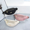 Drei Damen-Sport-Bauchtaschen in Schwarz, Pink und Beige auf kariertem Untergrund.
