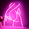 A glowing pink neon silhouette of a hand and arm on a wall.