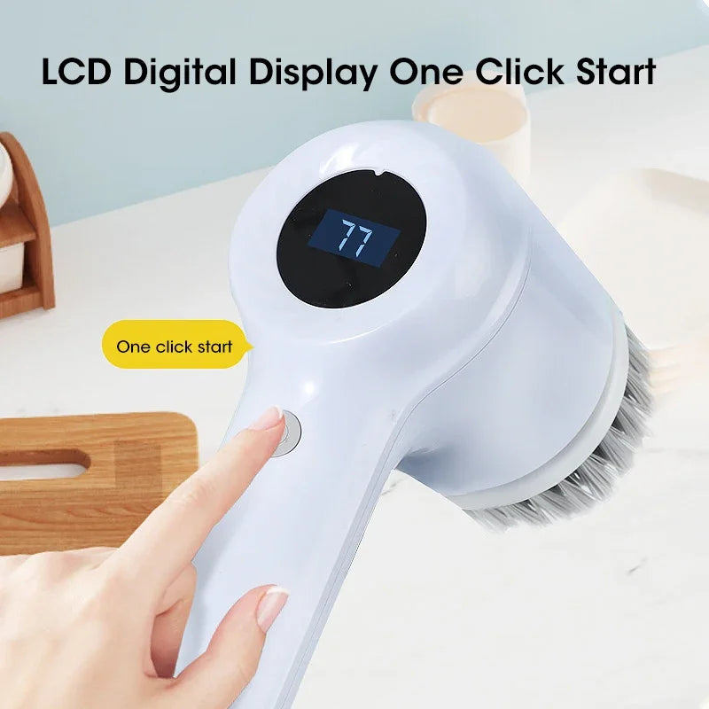 A hand is pressing the start button on a white cordless electric spin scrubber with a black digital display.