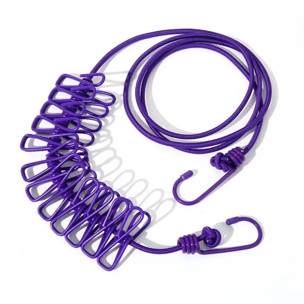 Purple elastic travel clothesline with non-slip clips coiled on a white background