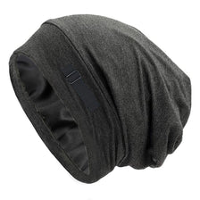 A dark gray silk-like night cap designed for long hair and curls.