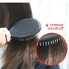 A black boar bristle hair brush is shown being used to remove dandruff from hair.