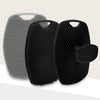 A set of two silicone body scrubbers or massage brushes, one silver and one black, shown against a light background.
