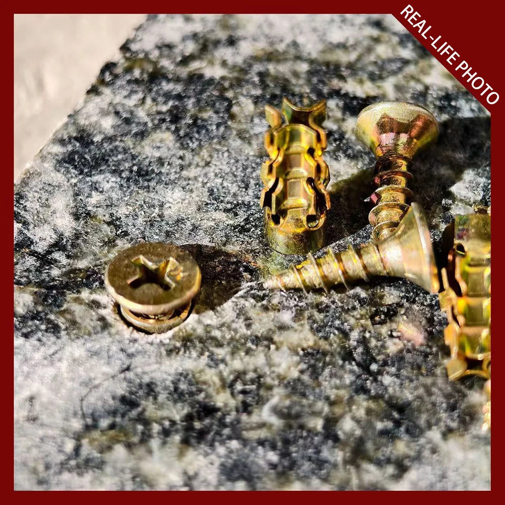Close-up photo of brass heavy-duty self-tapping wall anchors mounted on a dark, textured rock surface.