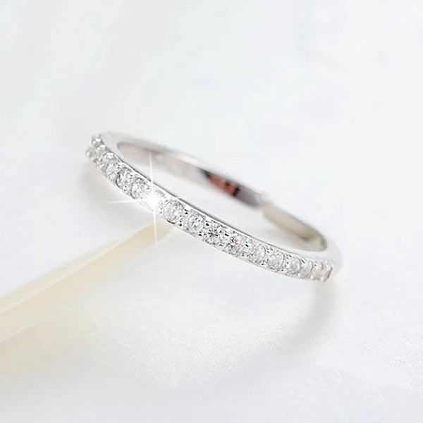 A close-up of an adjustable sterling silver ring set featuring pave-set zirconia stones.