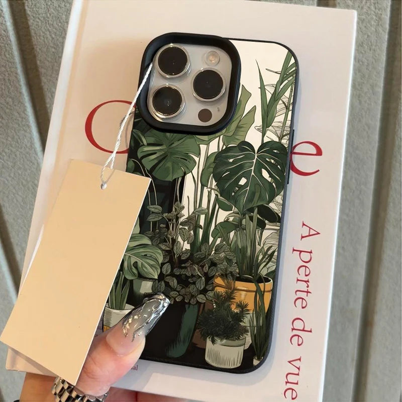 A phone case featuring a green monstera plant pattern for an iPhone, displayed on a white card.