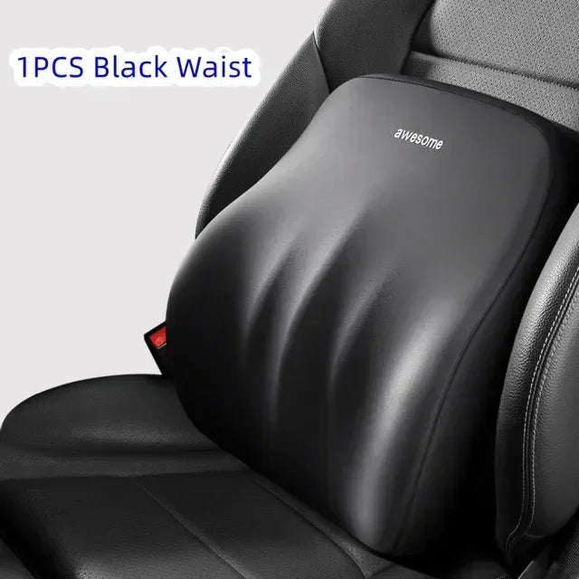 A black memory foam car headrest and lumbar support pillow placed on a dark car seat.