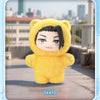 A yellow plush doll resembling a character from Jujutsu Kaisen is displayed against an outdoor city backdrop.