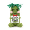 Hand-crocheted green positive energy doll with leafy hair holding a card