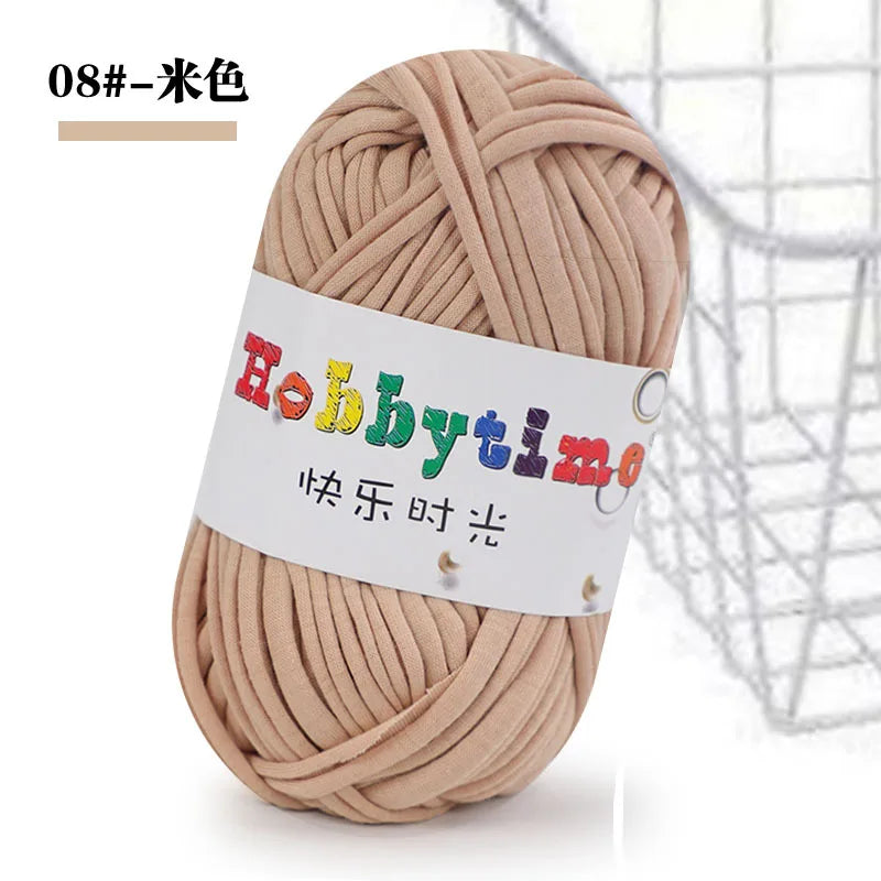 A ball of light beige soft T-shirt yarn for crochet and knitting is shown against a white background.