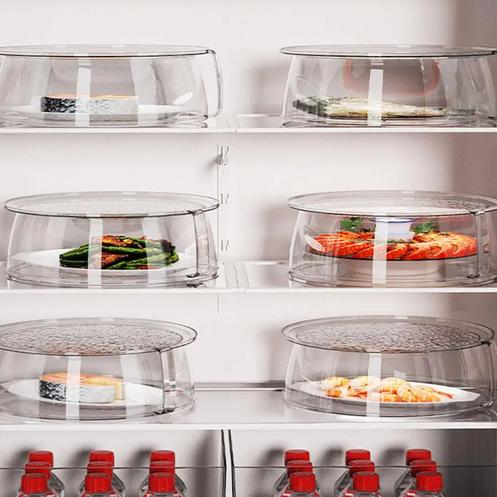 A display of clear microwave splatter covers with heat-resistant handles, holding various food items on a white shelf.