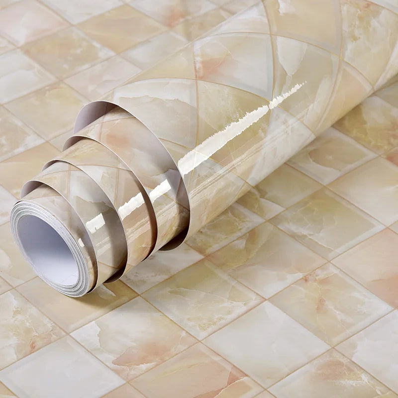 Roll of marble contact paper in beige and cream tones laid across a tiled surface.