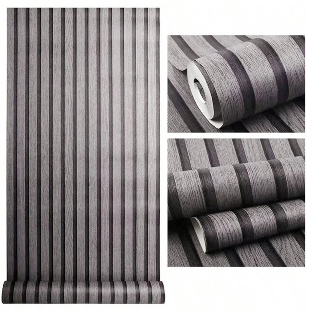 Rolls of wood grain self-adhesive wallpaper in gray tones showing vertical stripes and texture.