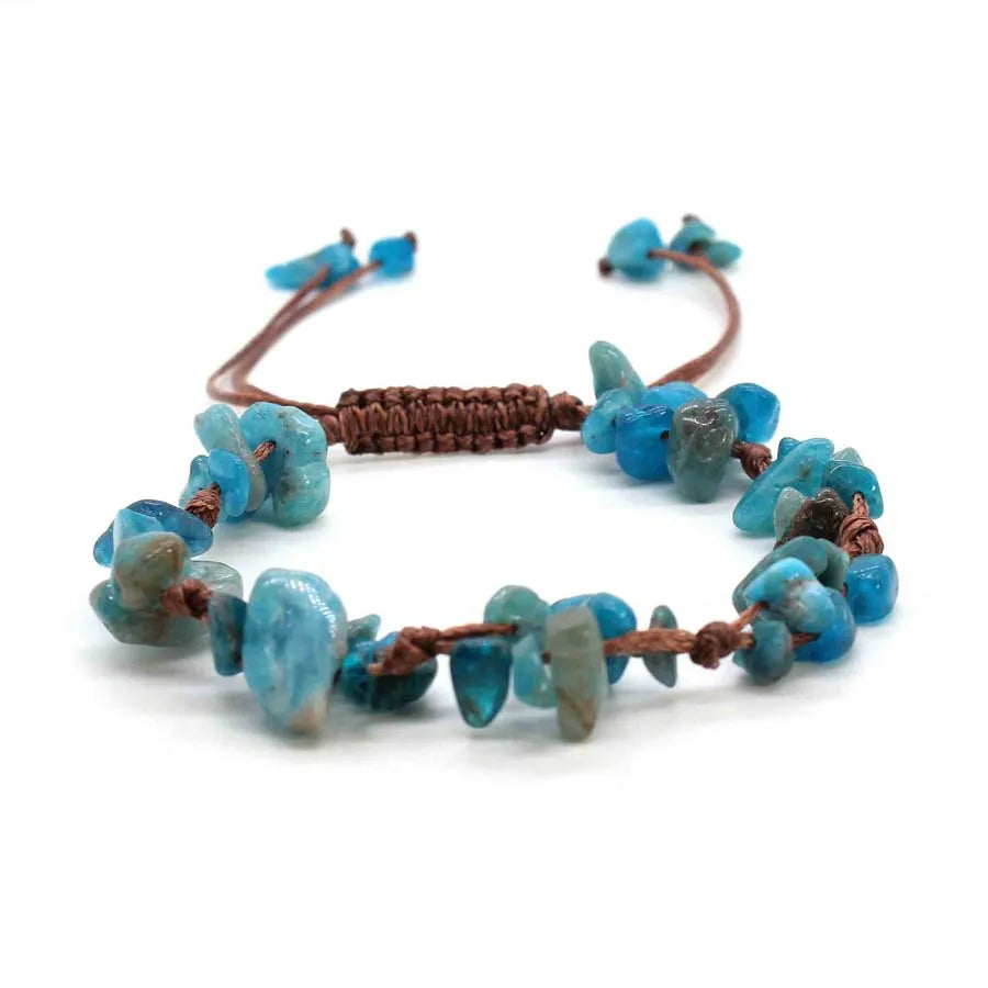 A close-up of braided crystal chip stone bracelets featuring blue and green natural quartz beads.