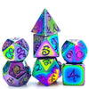 A set of seven metal polyhedral dice featuring a dragon font design in iridescent purple and blue colors.