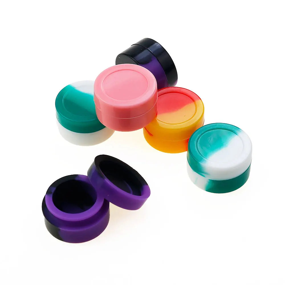 A collection of colorful flexible silicone travel jars in pink, orange, purple, and teal.