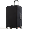 A black rolling suitcase with a silver handle and a protective cover attached.