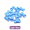 A pile of light blue plastic side-release buckles for paracord bracelet projects.