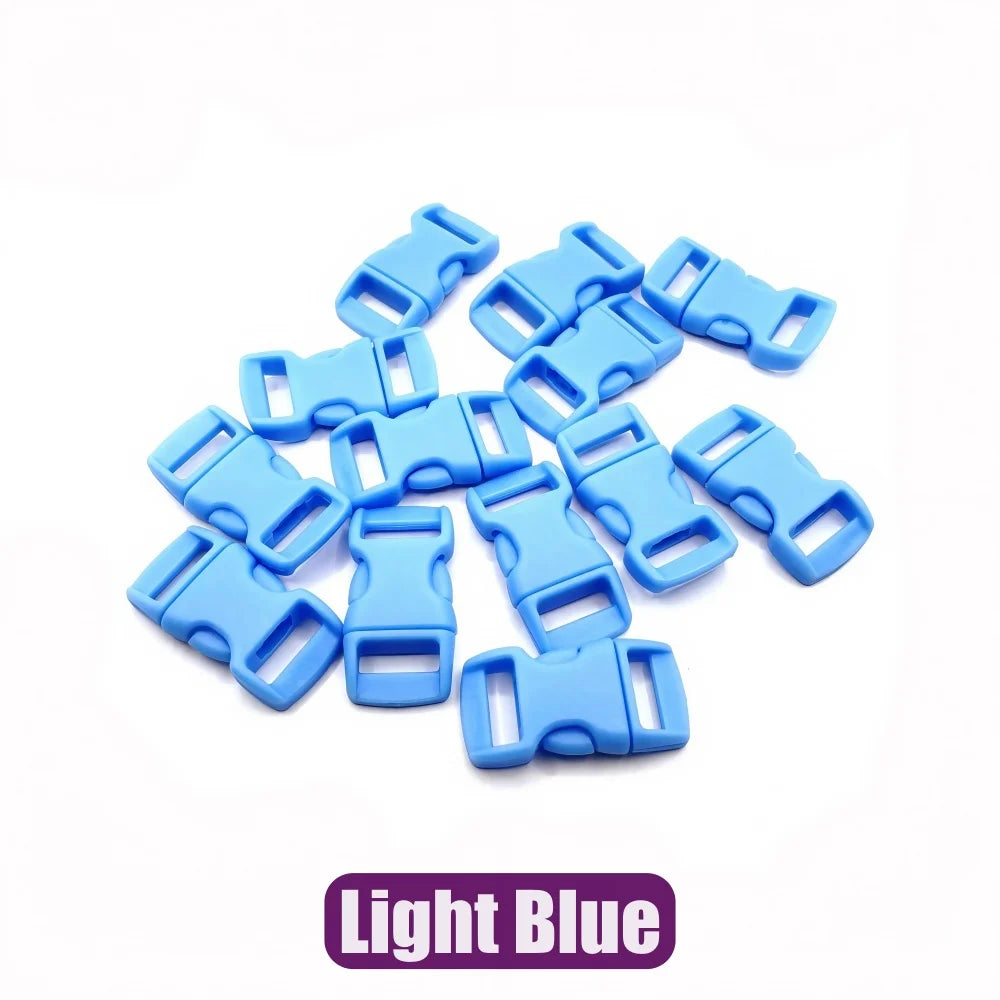 A pile of light blue plastic side-release buckles for paracord bracelet projects.
