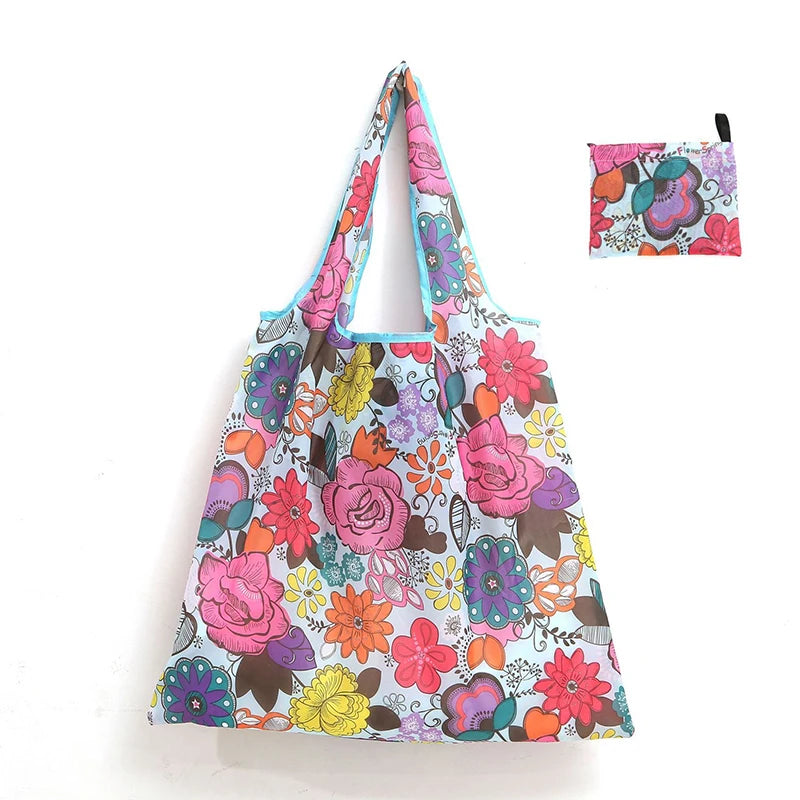 A colorful floral reusable shopping tote bag with a matching small carry pouch.