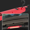 A red magnetic rechargeable work light with a hook is shown mounted on a car's interior panel.
