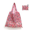 A pink and red reusable shopping tote bag with a matching carry pouch featuring a pattern of cats.
