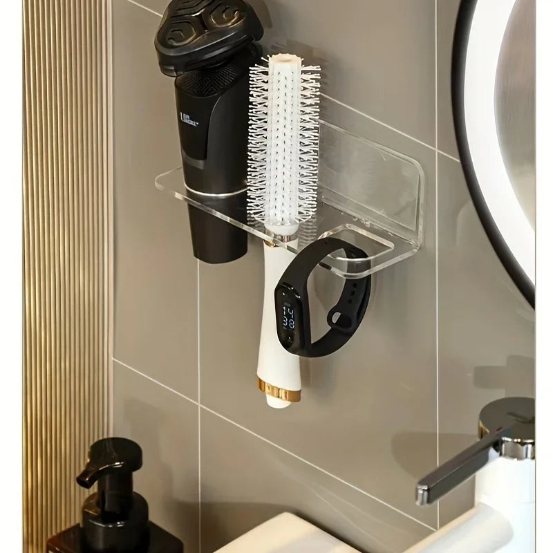 Wall-mounted acrylic organizer holding a hairbrush and comb on a white dispenser.