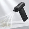 A black high-speed cordless air duster is shown emitting a fine mist of air onto a white surface.