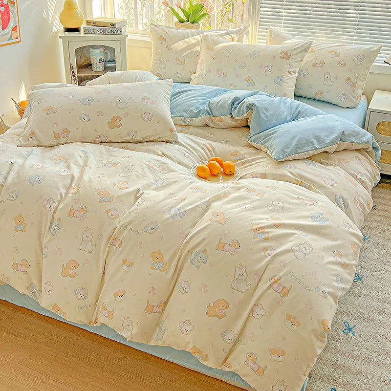 A light yellow floral duvet cover set with a blue accent and matching pillows on a bed.