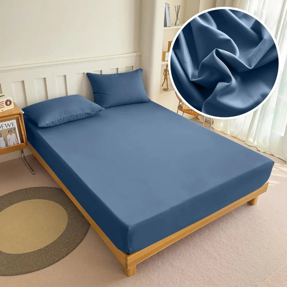 A folded blue fitted bed sheet with an elastic band is displayed on a wooden bed frame.