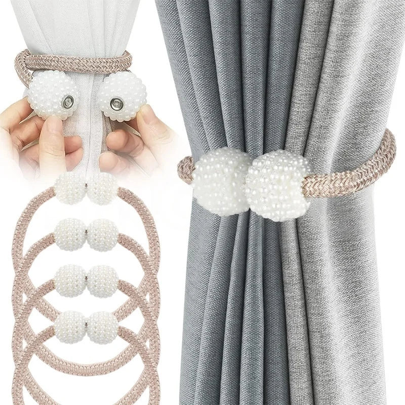 Pearl magnetic curtain tiebacks with a braided cord and pearl accents used to hold gray fabric curtains.