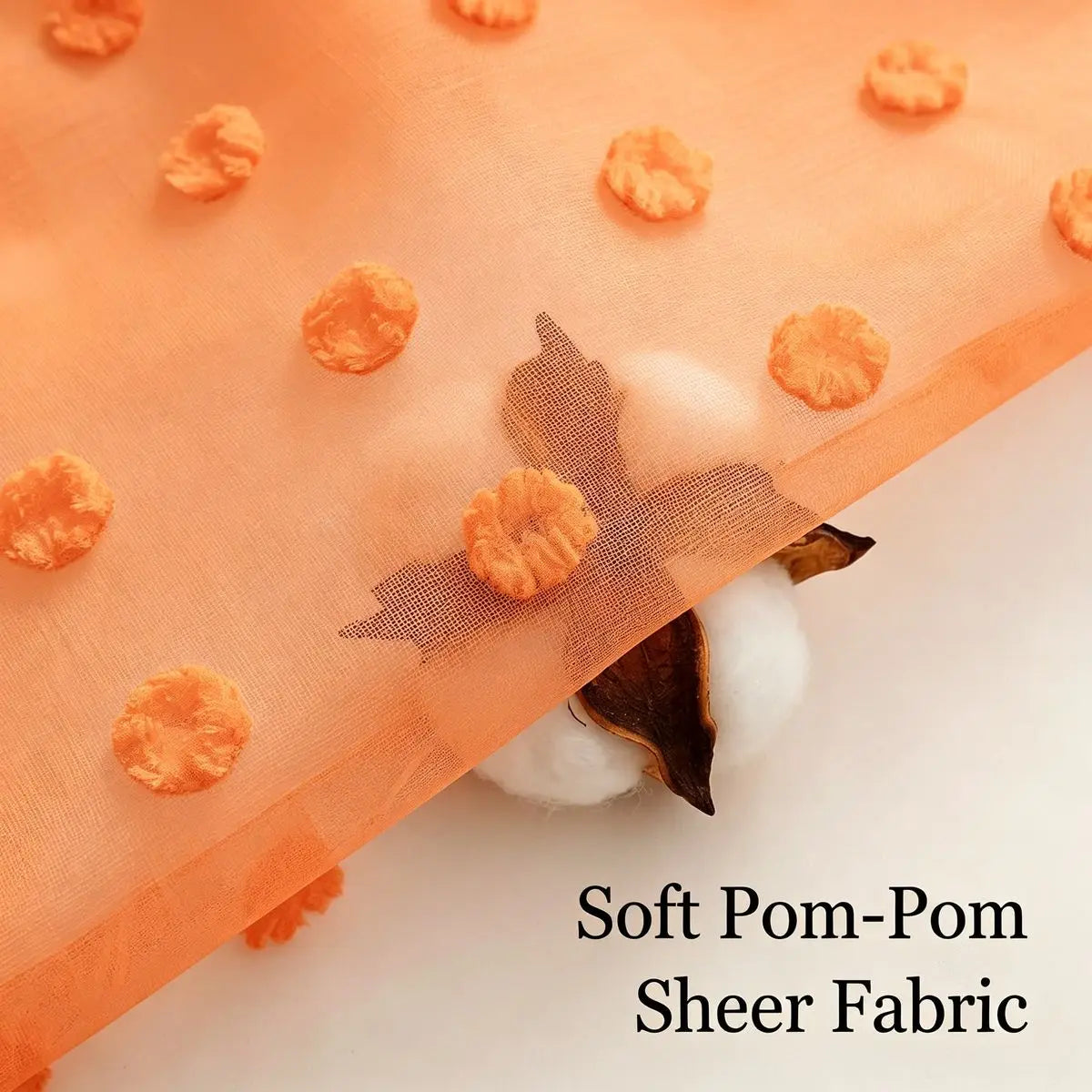 Orange pom-pom sheer fabric with a 3D jacquard rod pocket