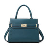 A dark teal leather handbag with a top handle and matching coin purse.