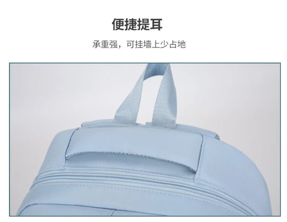 Light blue urban nylon backpack shown from the front, featuring adjustable straps.