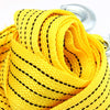 Yellow heavy-duty vehicle recovery towing strap coiled and visible with a metal hook.