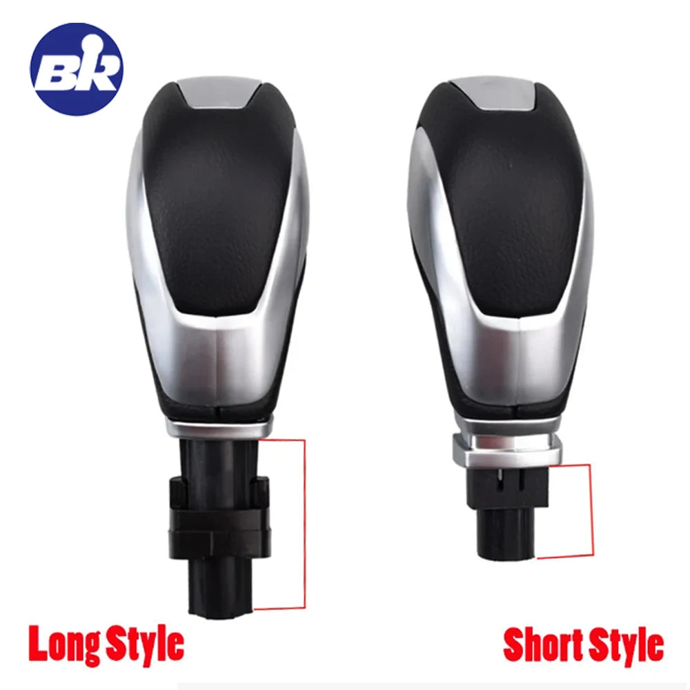 A pair of gear shift knobs, one long style and one short style, for a Ford vehicle.