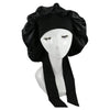A black satin sleep cap with ruffled edges displayed on a mannequin head.