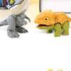 A gray dinosaur figurine stands next to an orange and green dinosaur figurine on a light yellow background.