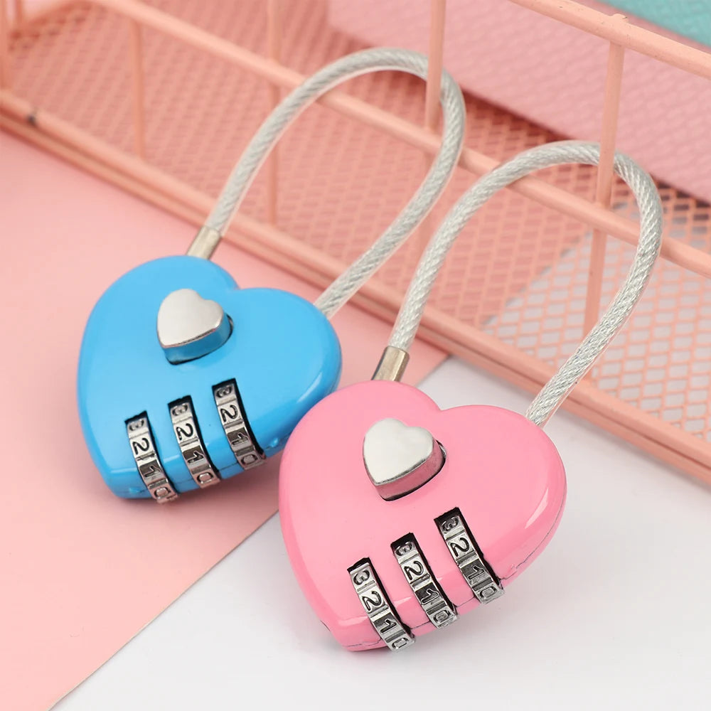 Pink heart-shaped padlock with a white cord and silver combination dial resting on a pink surface.