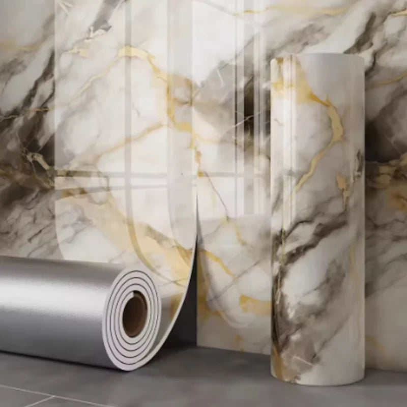 Roll of self-adhesive marble wallpaper featuring white and gold veining on a wall surface.