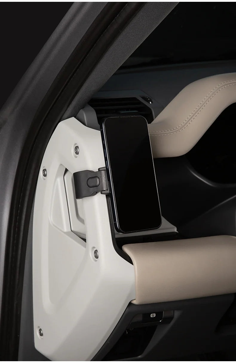 A magnetic car phone mount with a cup holder base is shown inside a vehicle door panel.